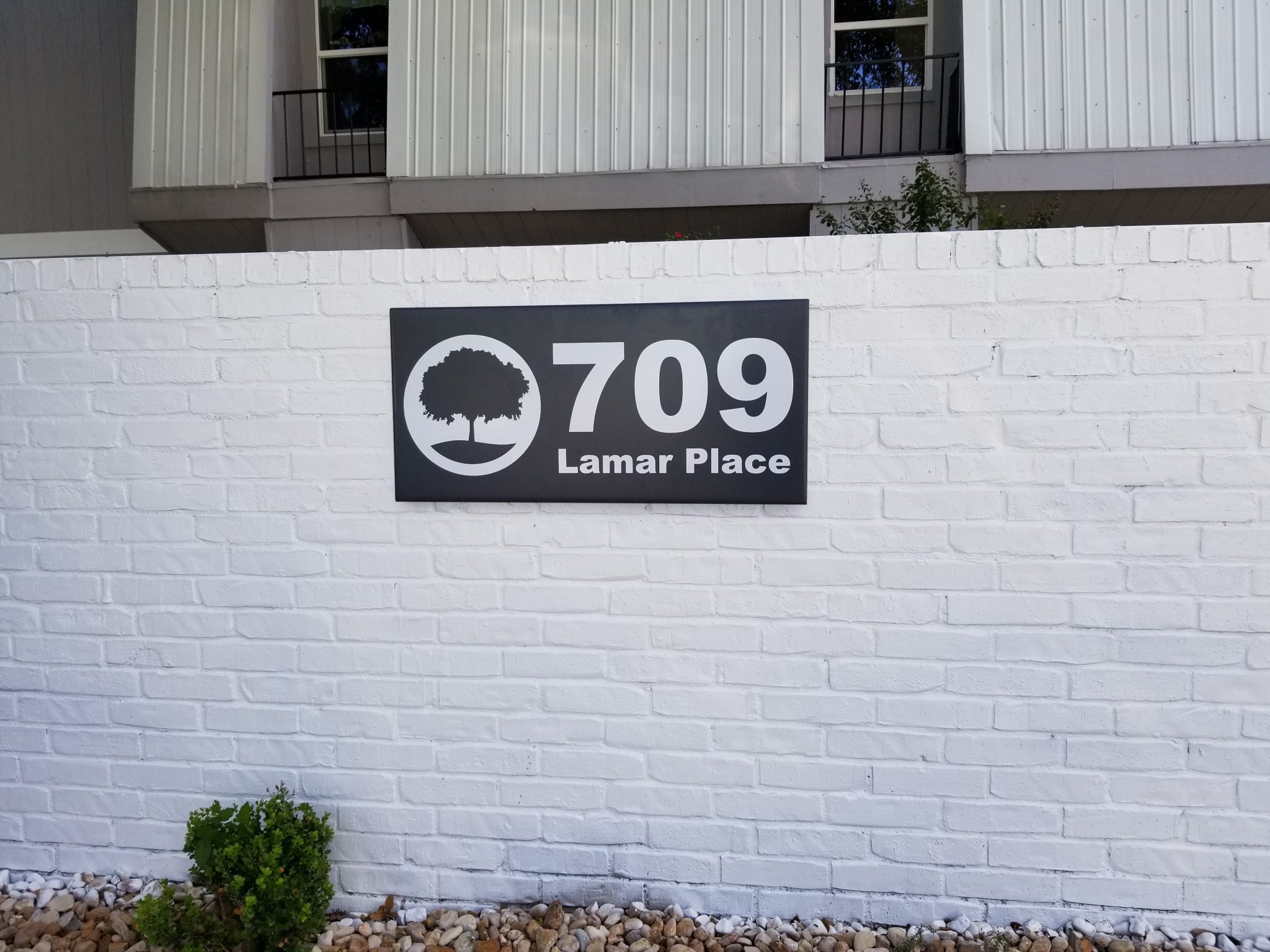 Custom address monument sign at a property entrance