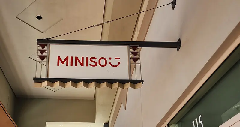 Illuminated projecting blade sign after dark