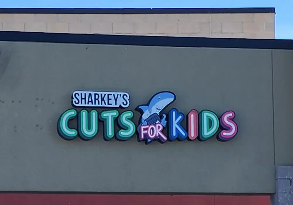 Custom business sign fitted to a storefront facade