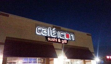 Illuminated building sign visible after dark