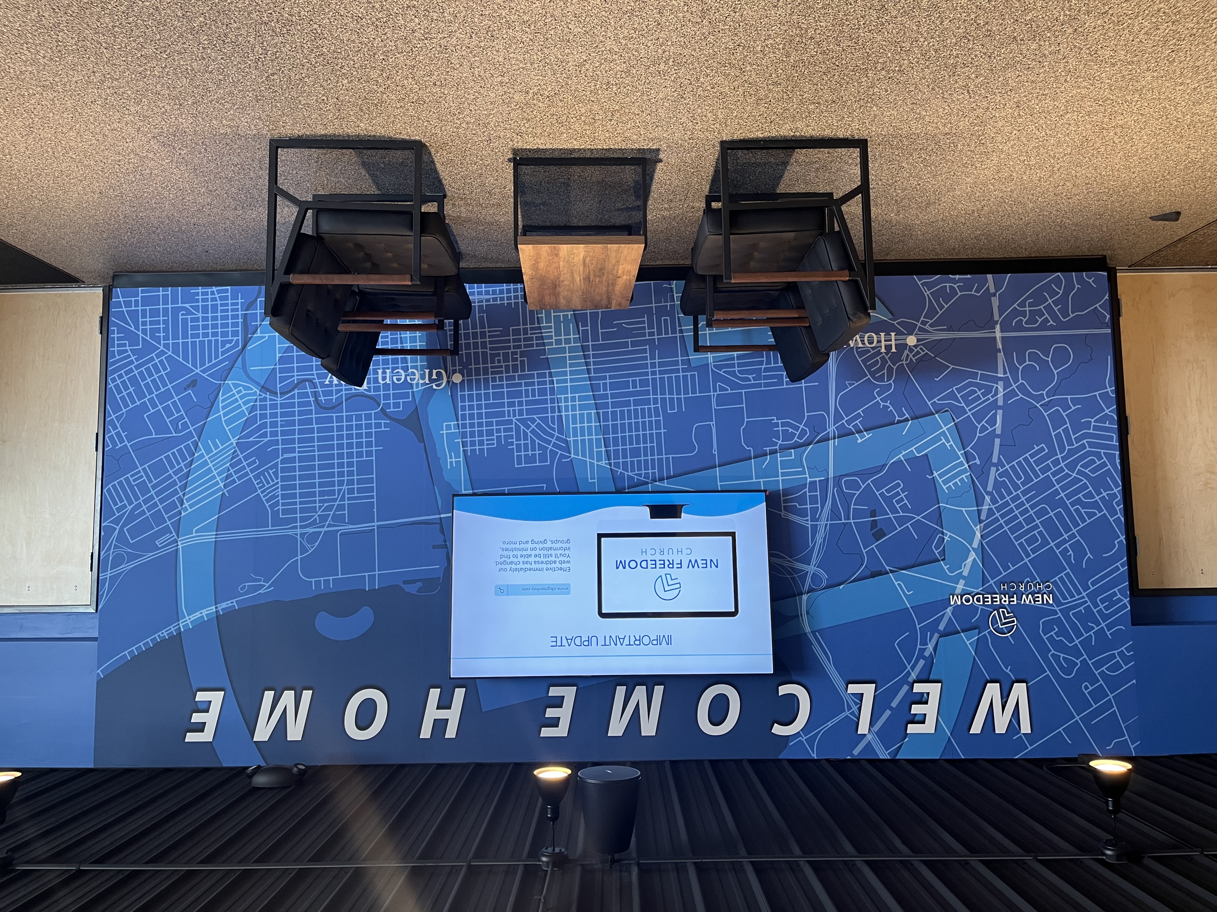 New Freedom Church lobby featuring a full blue city-map wall mural with dimensional welcome letters