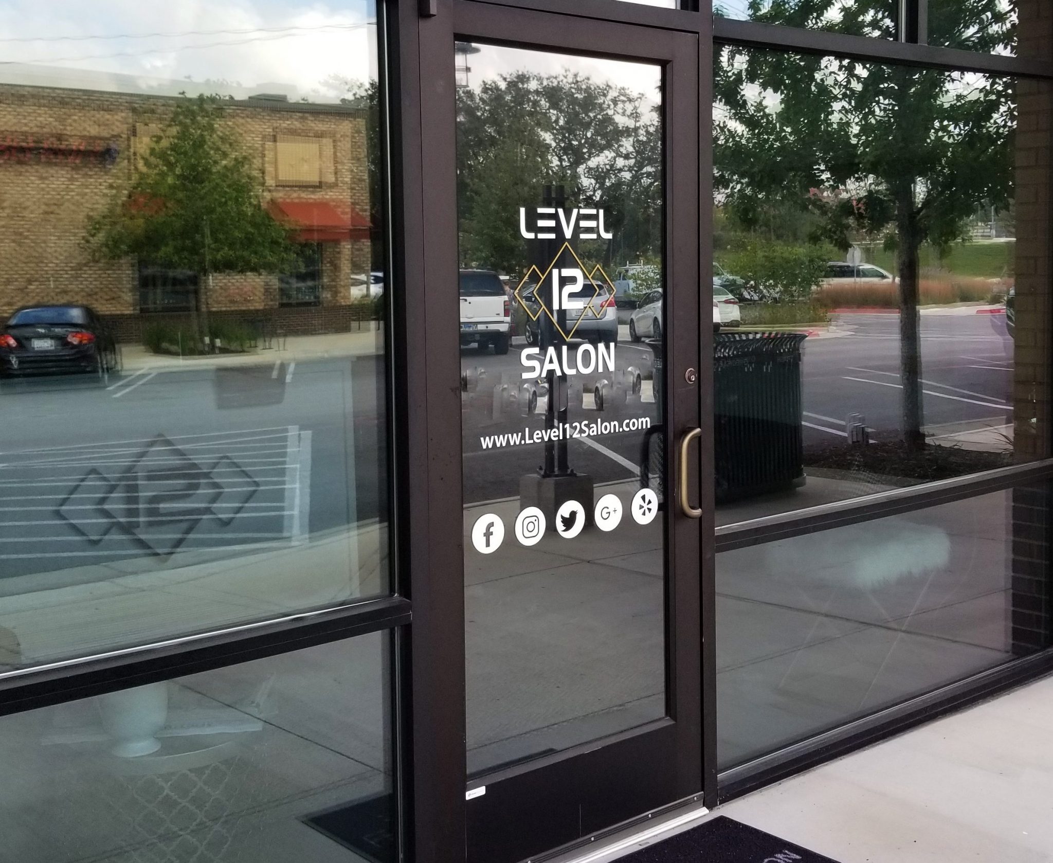 Custom business name and information graphics on an entrance door