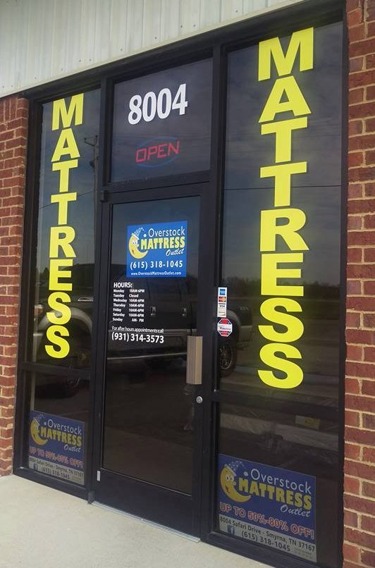 Custom vinyl hours and information displayed on a glass door