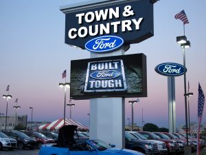 Custom electronic message center integrated into a pole sign
