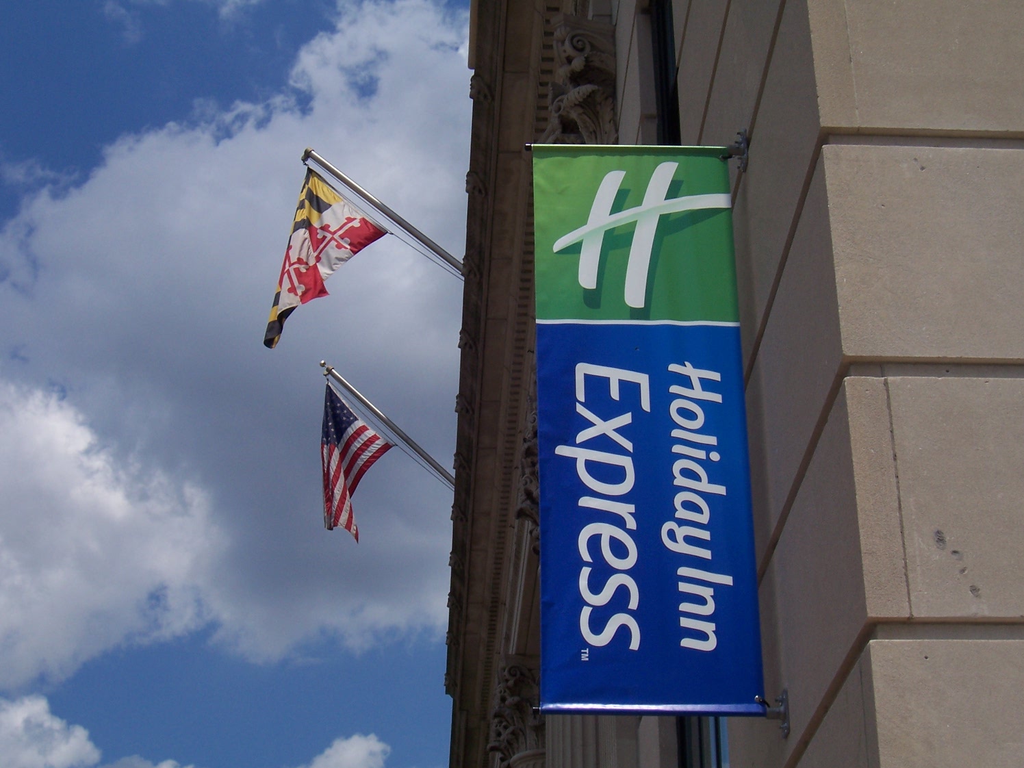 Promotional flag sign displayed outside a storefront
