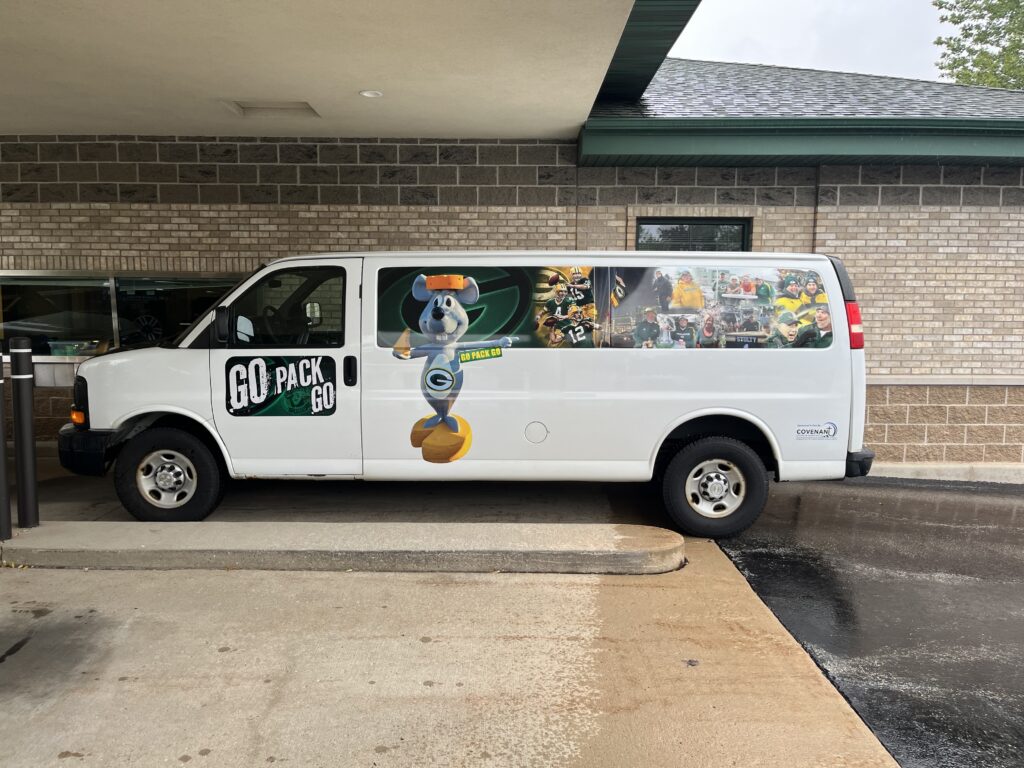 Wrapped work van with Go Pack Go Green Bay graphics applied by Covenant Signs and Graphics