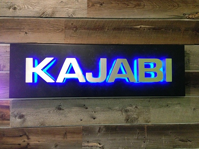 Backlit LED logo sign installed in a lobby