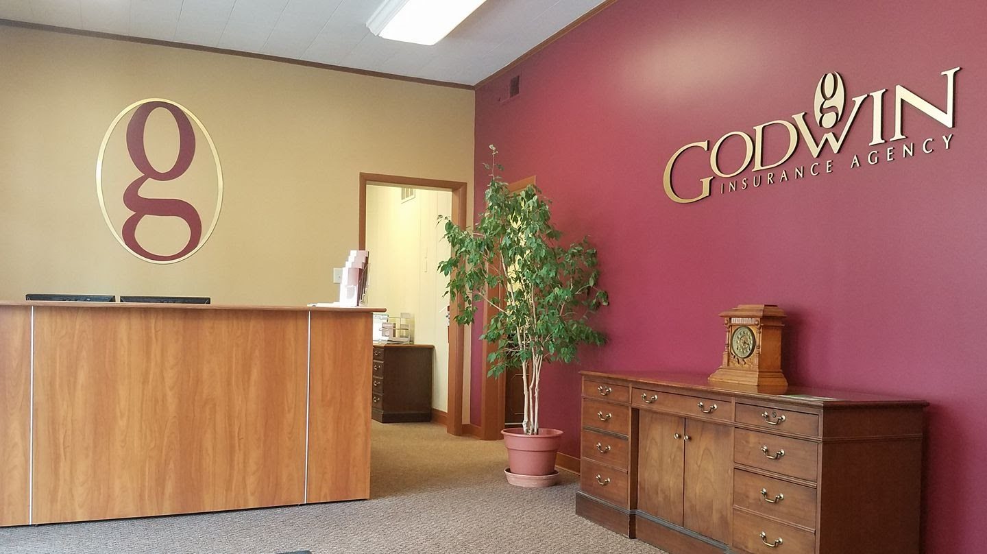 Godwin Insurance Agency wall logo inside a reception lobby