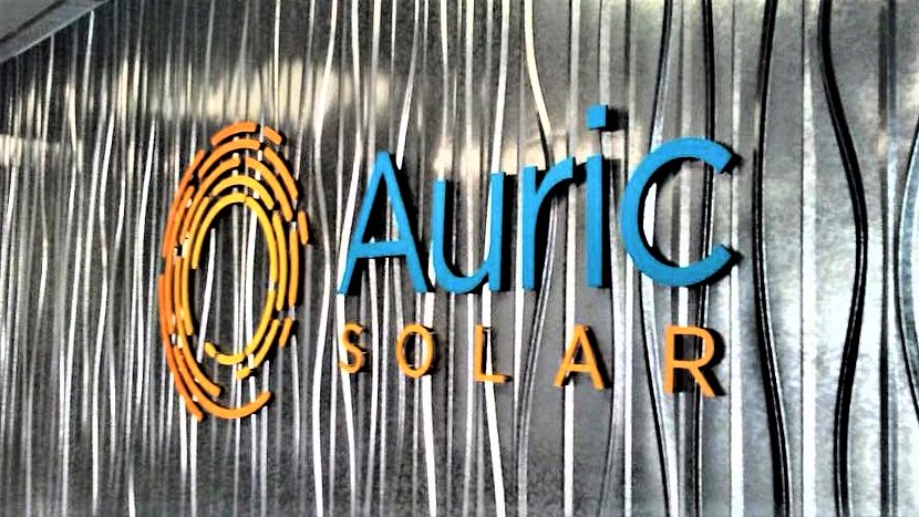 Custom metal logo sign inside a business lobby