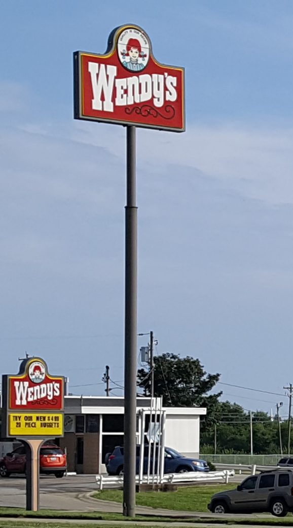 Tall custom pole sign identifying a roadside business