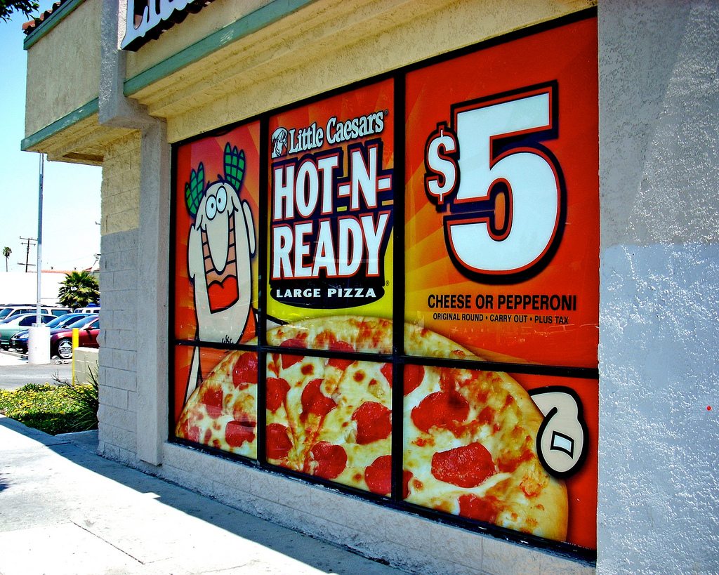 Custom promotional window graphics on a storefront