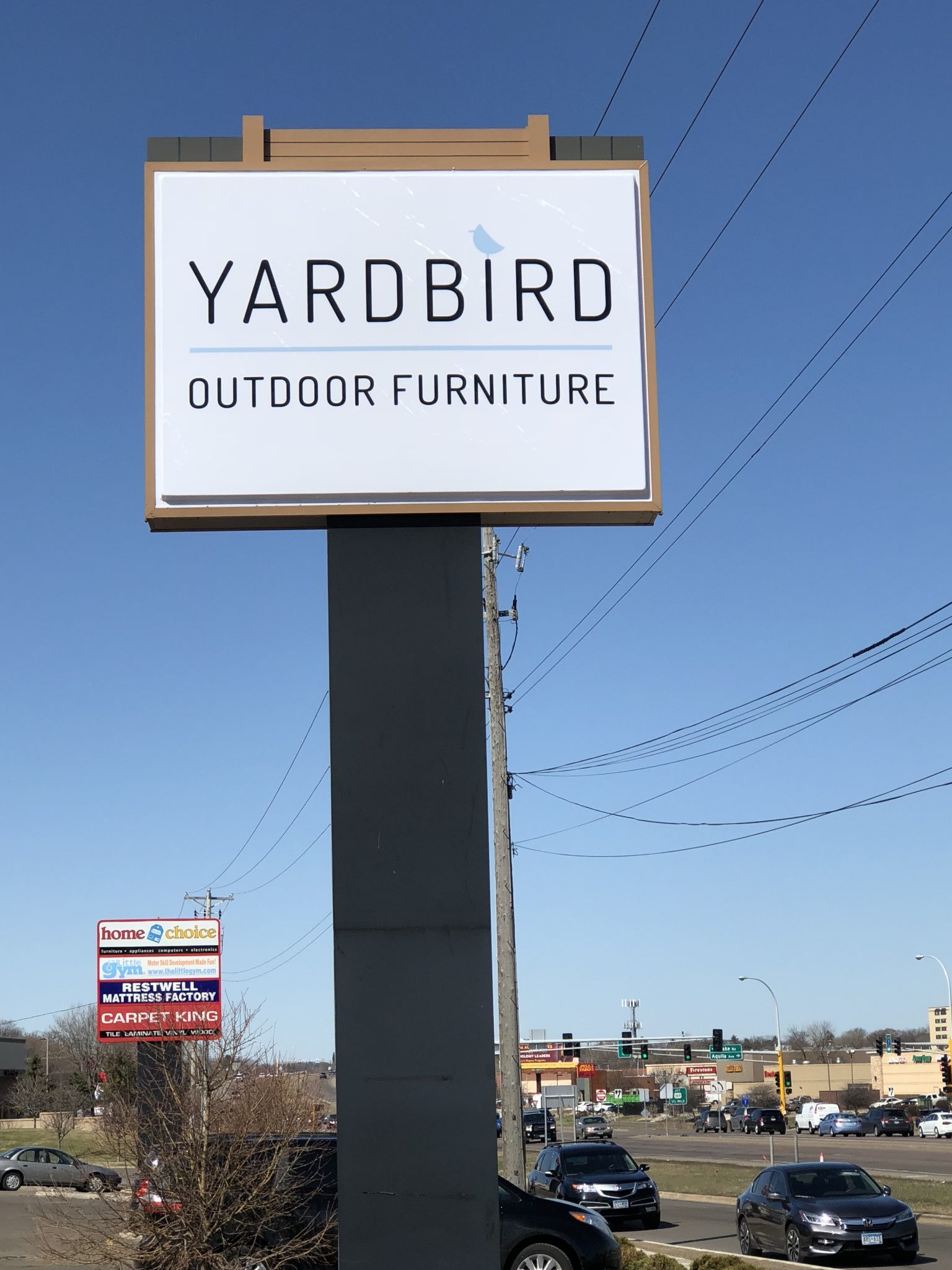 Tall branded pylon sign beside a commercial roadway