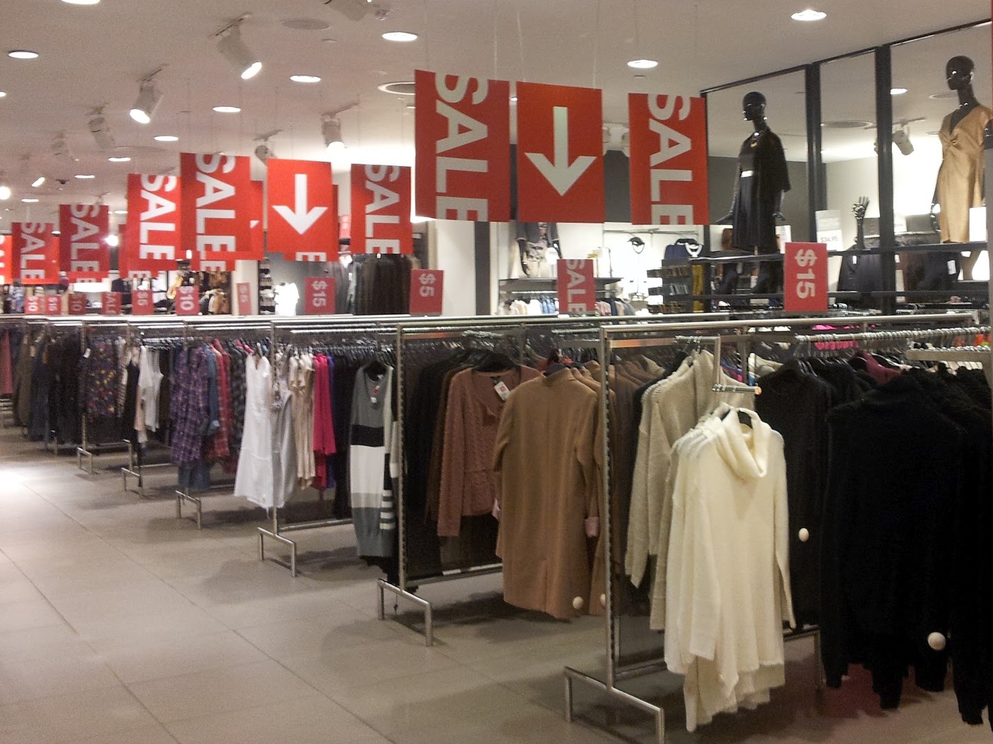 Indoor promotional signs guiding customers through a retail store