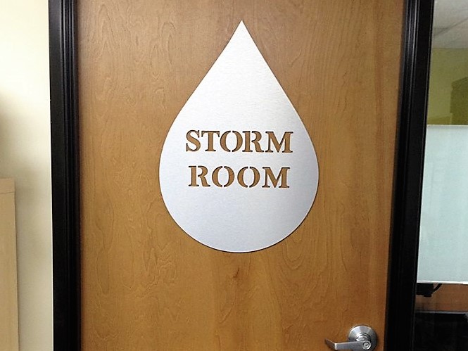 Custom room identification sign installed beside an interior door