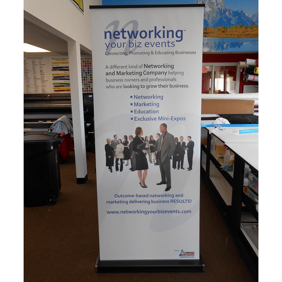 Retractable banners and graphic elements in a trade show exhibit