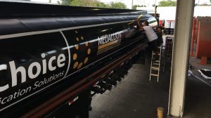 Custom commercial trailer wrap with large branded graphics