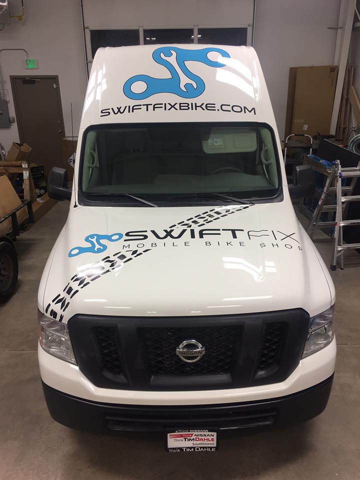 Custom branded graphics covering a commercial transport van