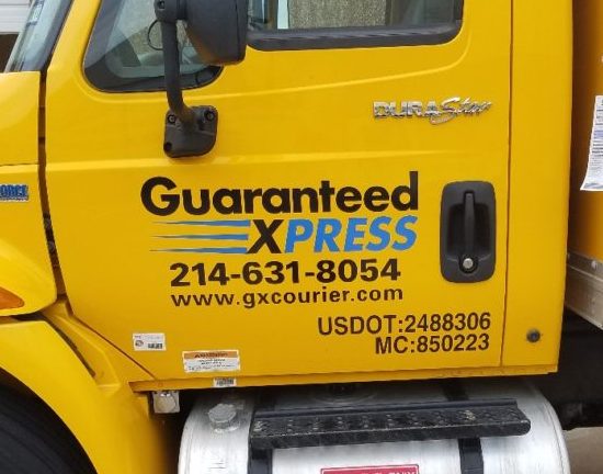 Commercial truck lettering including identification and regulatory details