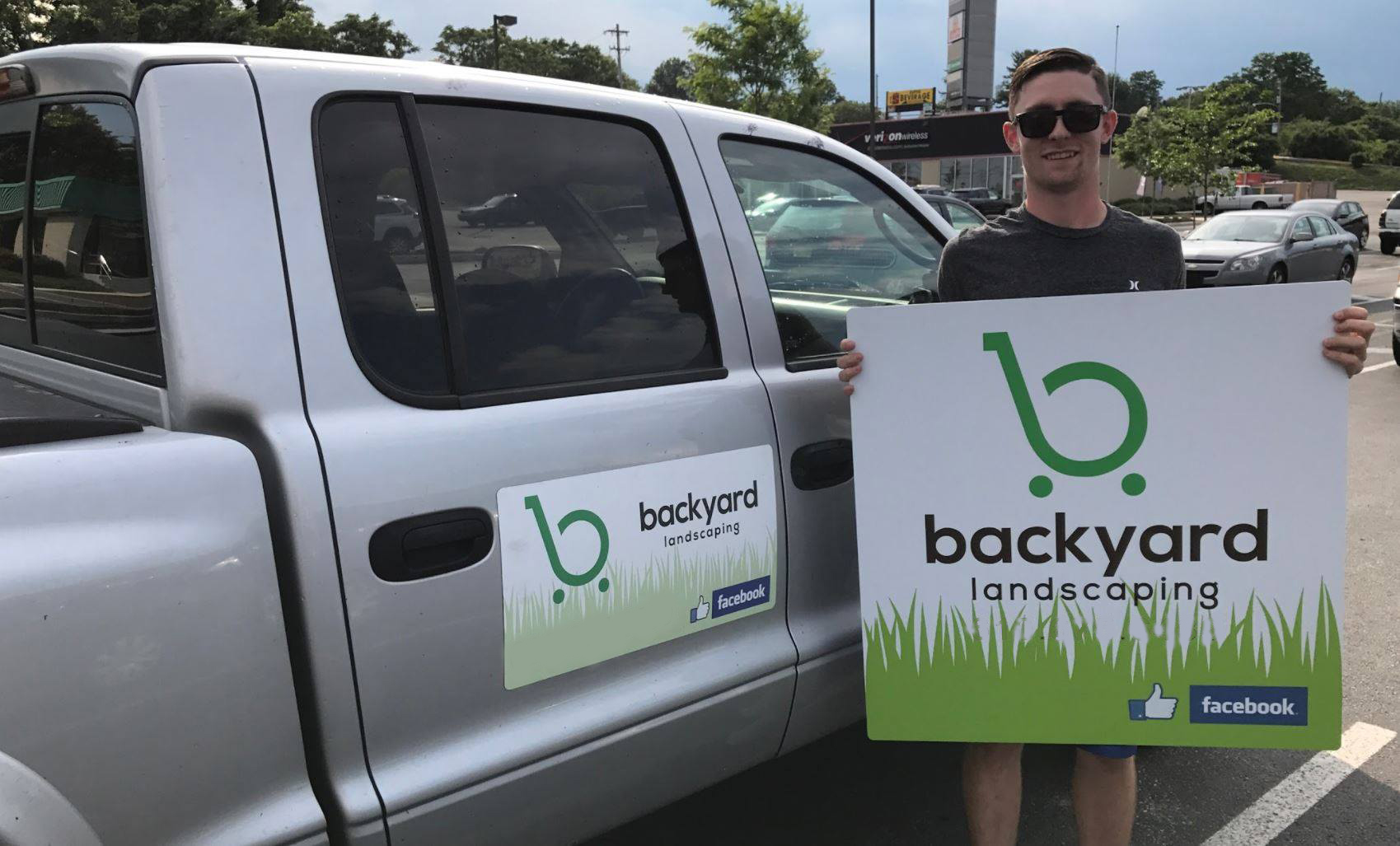 Branded magnetic business sign attached to a work vehicle